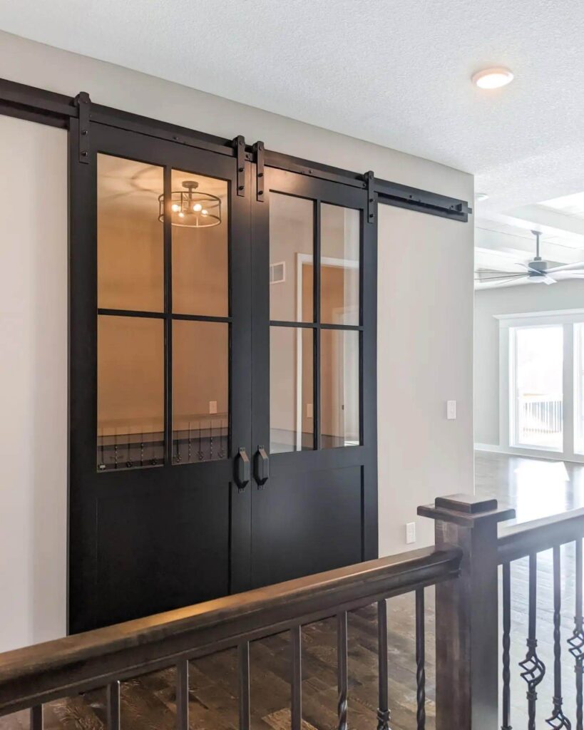 6. Sliding Barn-Style Glass Doors with Matte Black Finish
