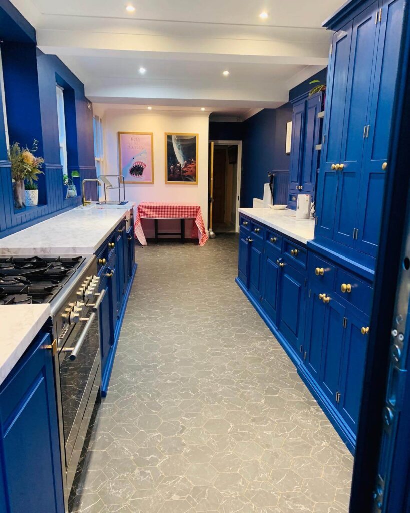 11. Moody Luxe with Navy Cabinets and Veined Marble