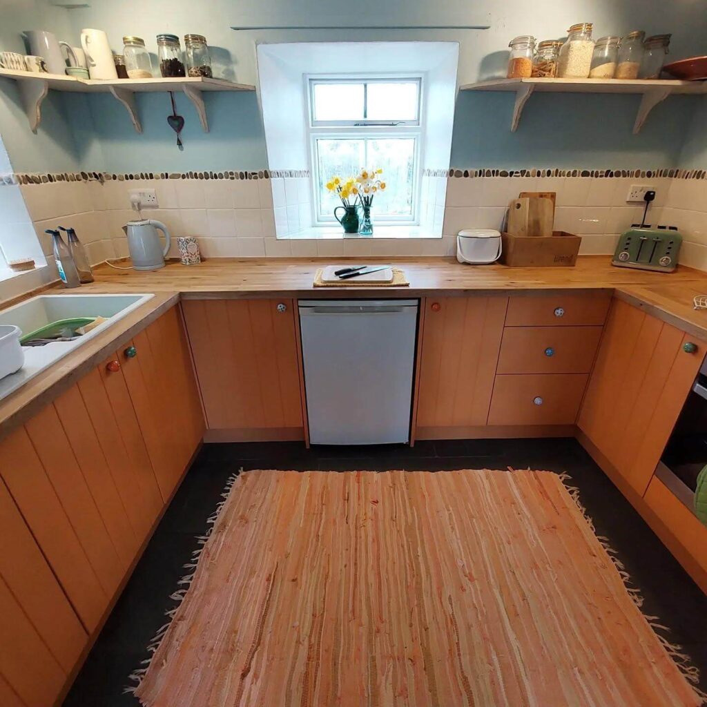16. Industrial Elegance: Matte Orange Cabinets with Mixed Woods