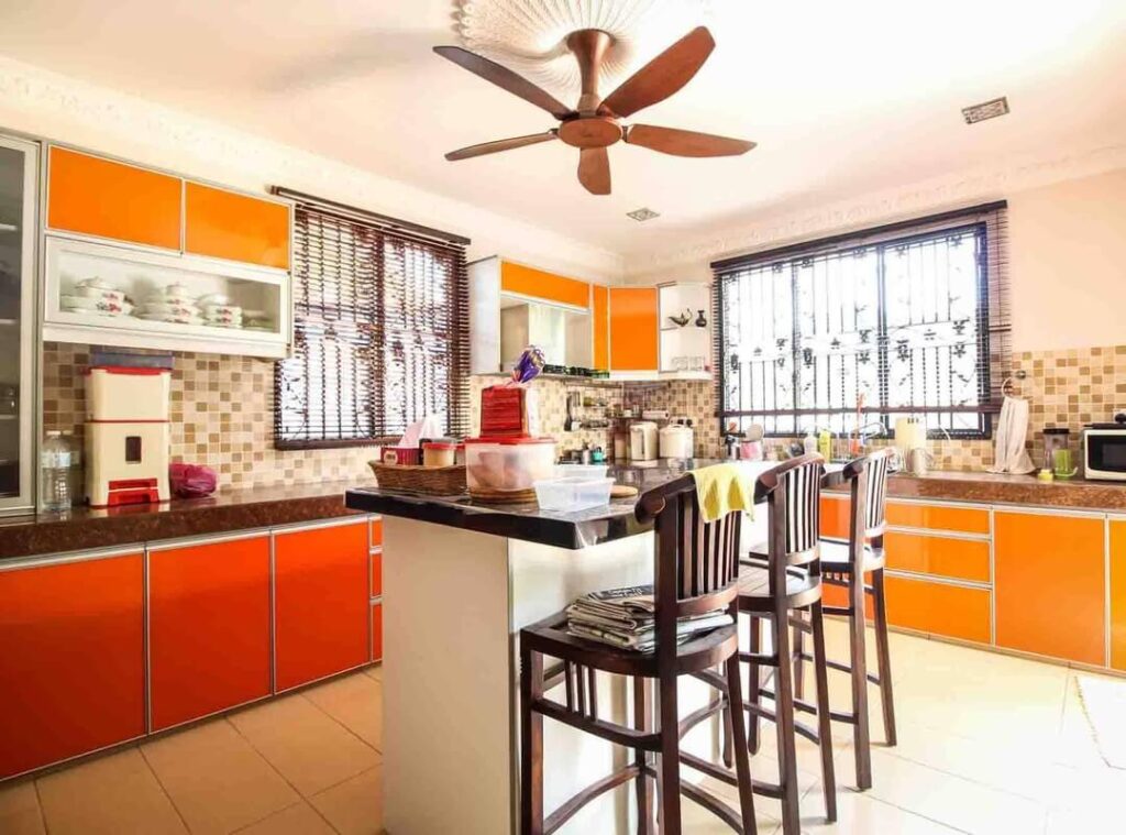 17. Contemporary Boldness: Ultra-Modern Orange Kitchen with Sleek Lines