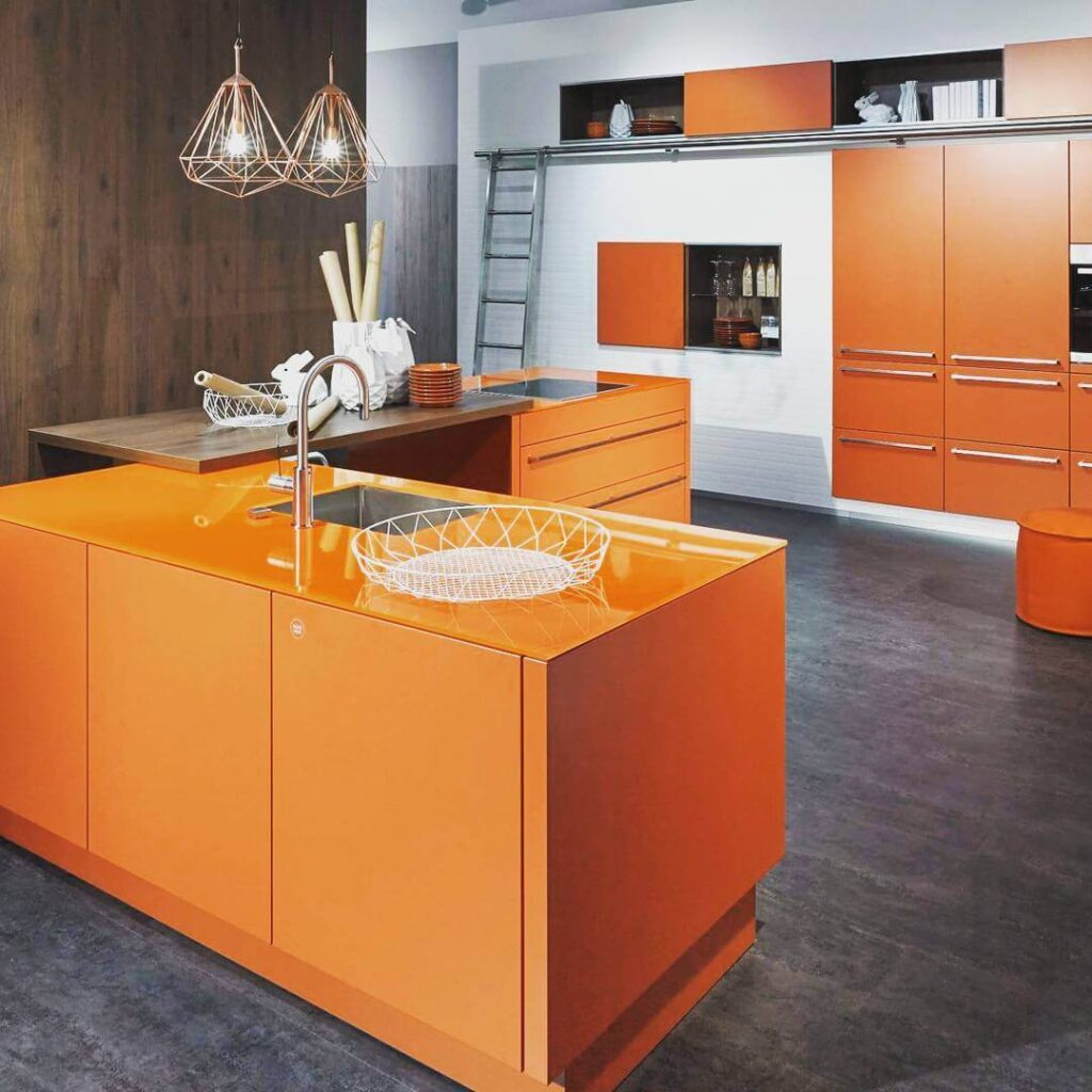 18. Functional & Friendly: Orange Cabinets with Breakfast Bar Comfort