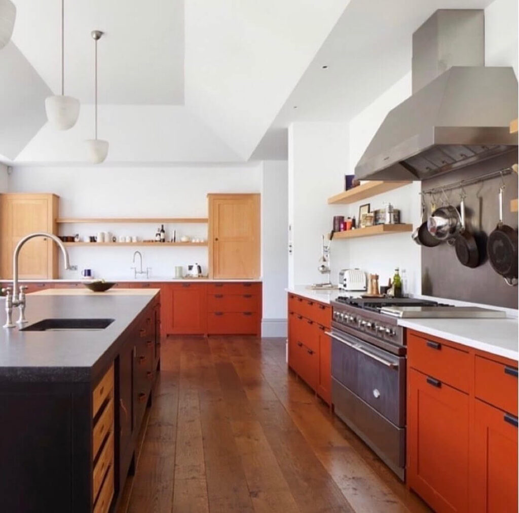 19. Cottage Charm: Muted Orange in a Cozy Country Kitchen