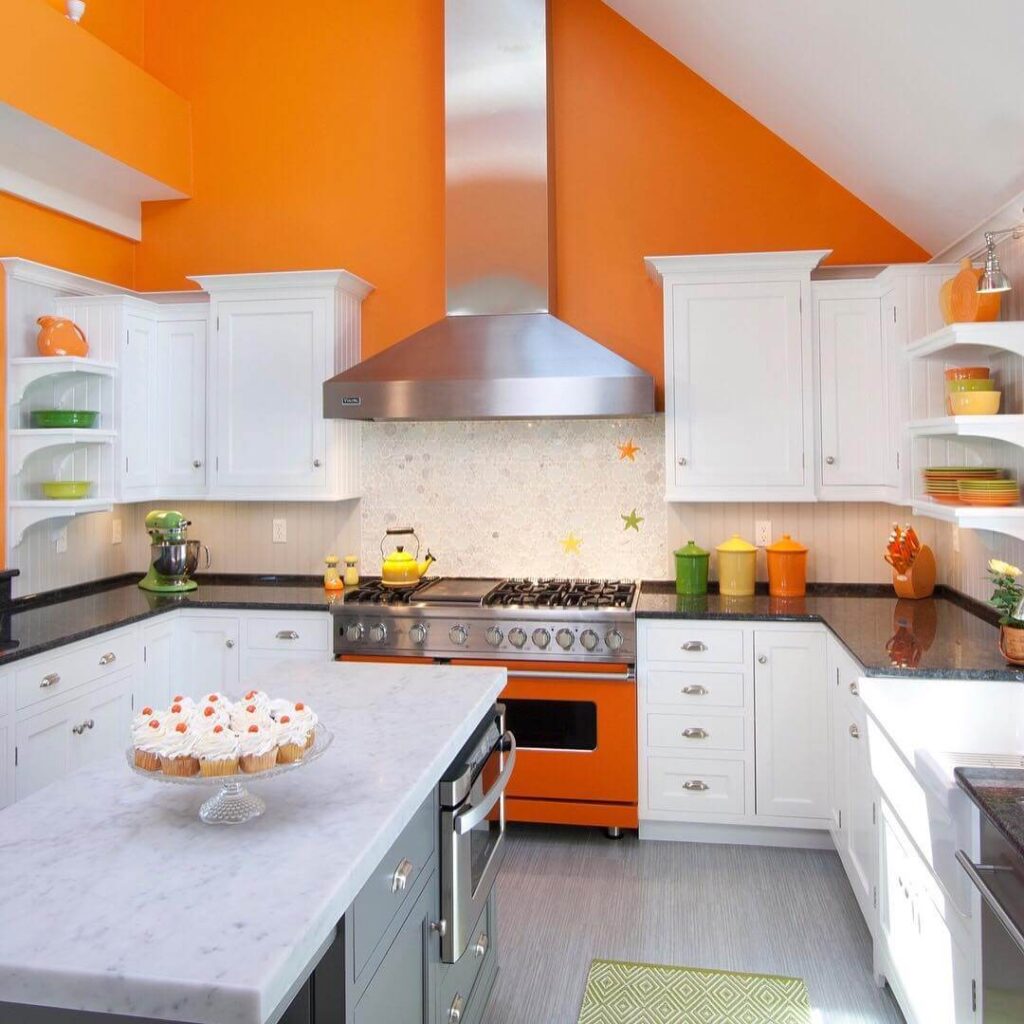 20. Pop Art Bright: Orange Walls and Accents in a White Kitchen