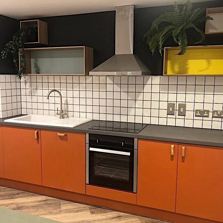 24. Sleek Scandinavian: Orange Cabinets with Minimalist Contrast