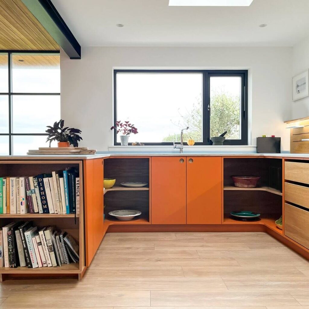 25. Open & Airy: Orange Base Cabinets with Built-In Bookshelves