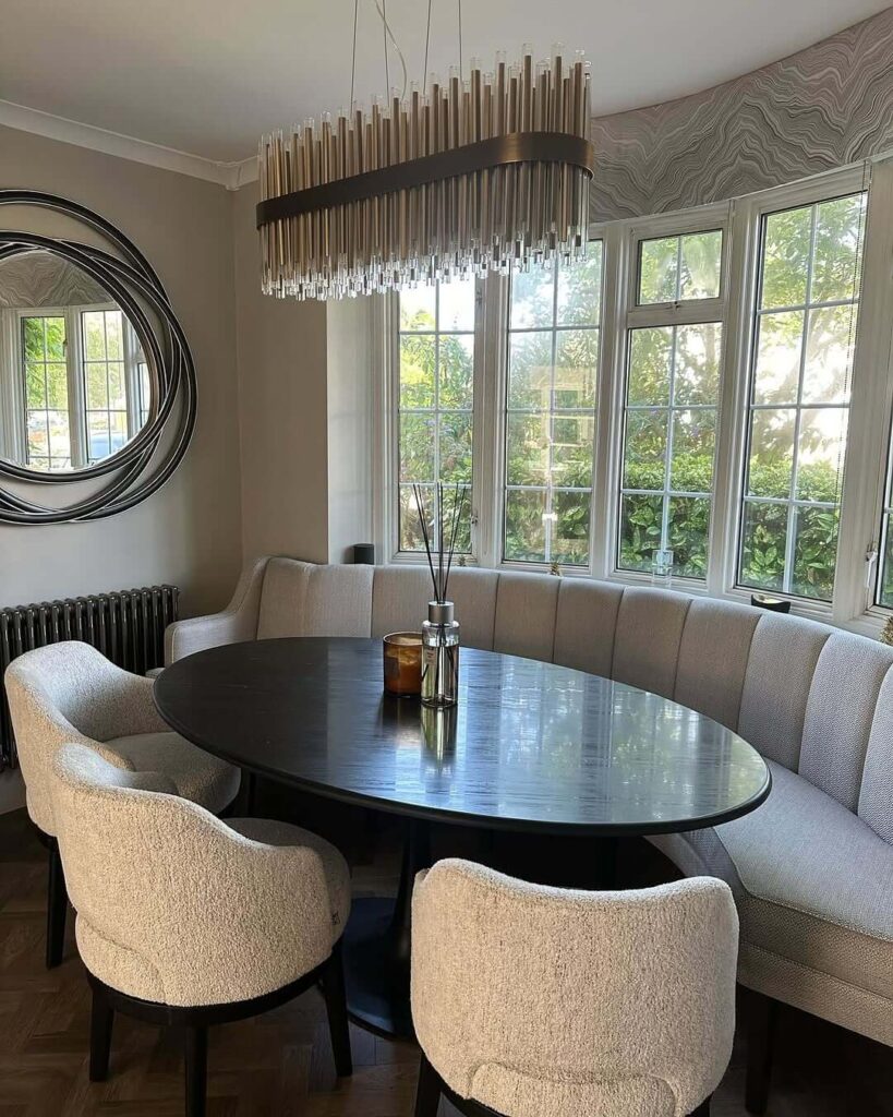 6. Curved Banquette with Bouclé Chairs: A Cozy Corner Reimagined