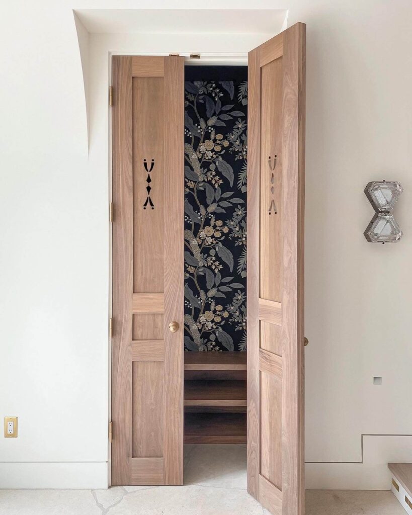 8. Natural Wood Doors with Vintage Cutouts and Wallpaper Backdrop