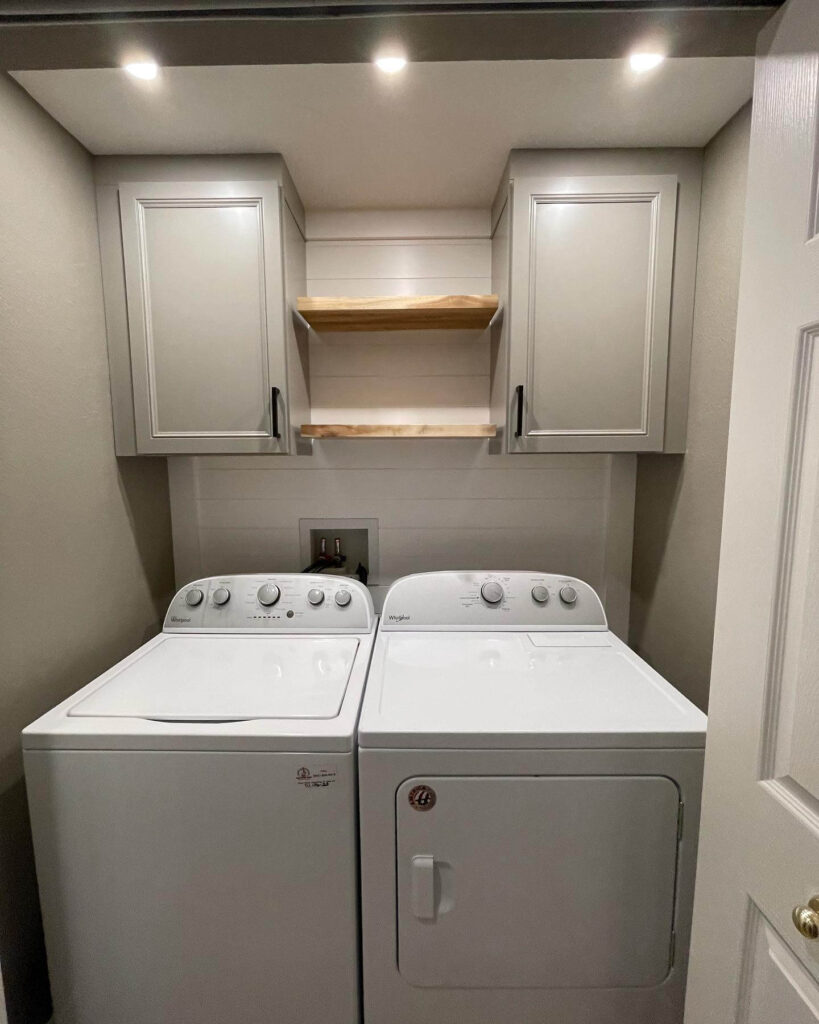 12. Streamlined Laundry Closet with Task Lighting and Built-ins