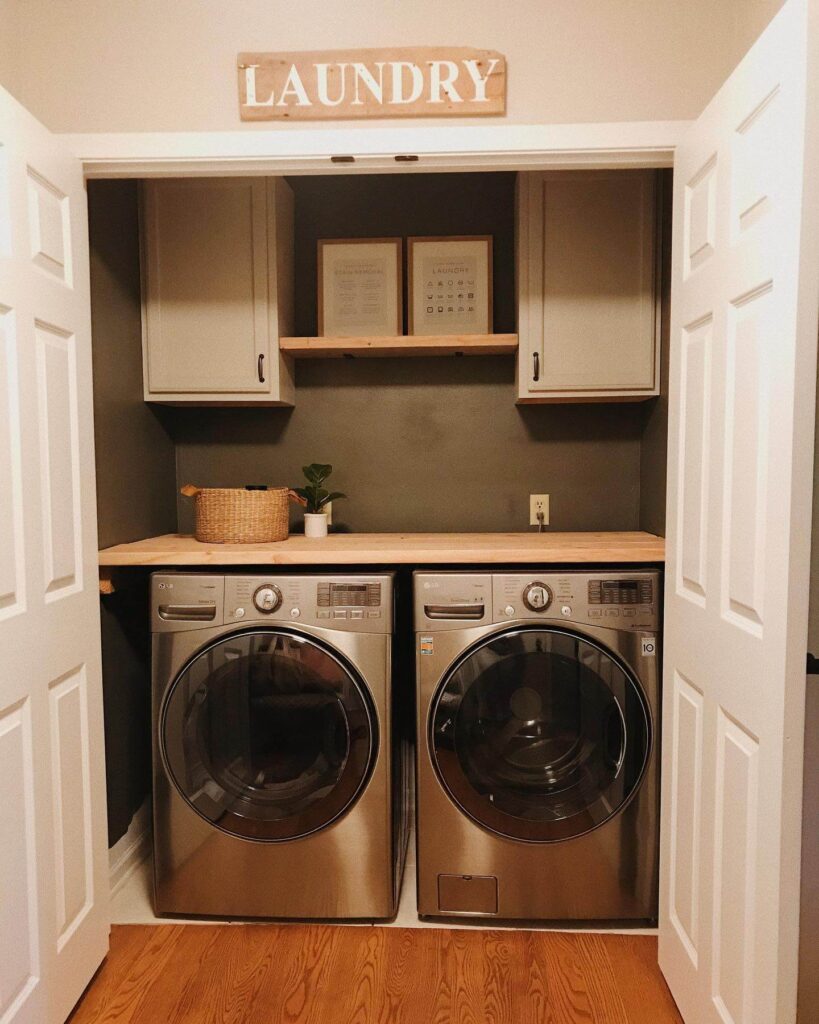 15. High-Contrast Monochrome Laundry Closet with Bold Wallpaper