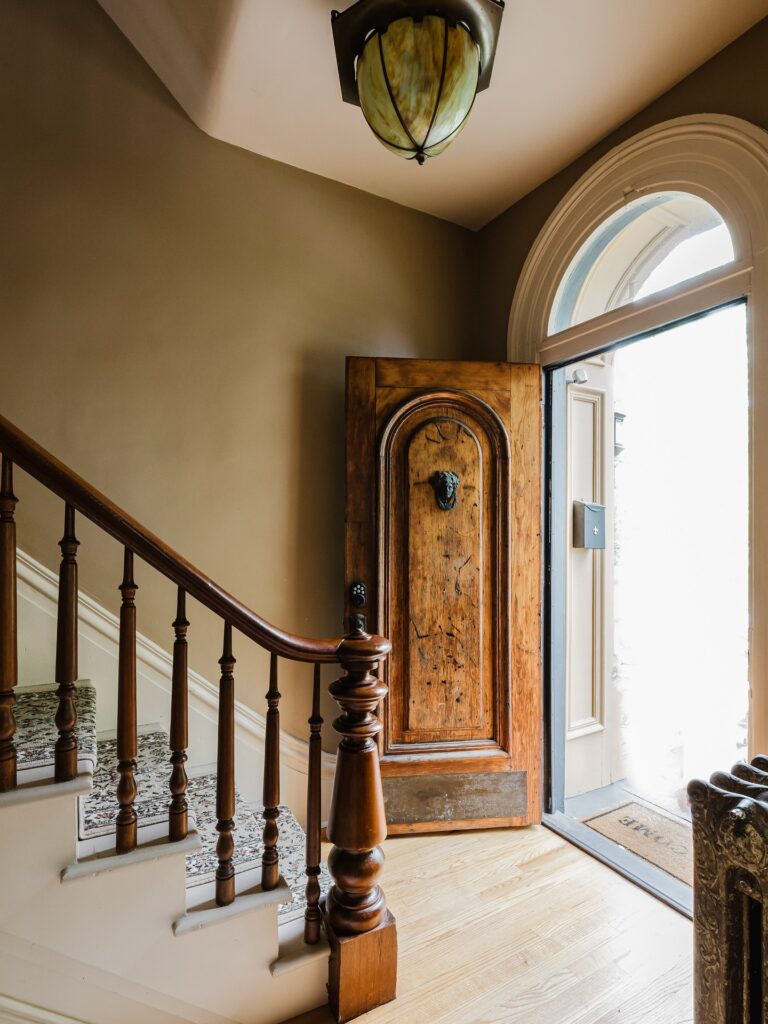 23. Whimsical Teal Door with Arched Top Frame