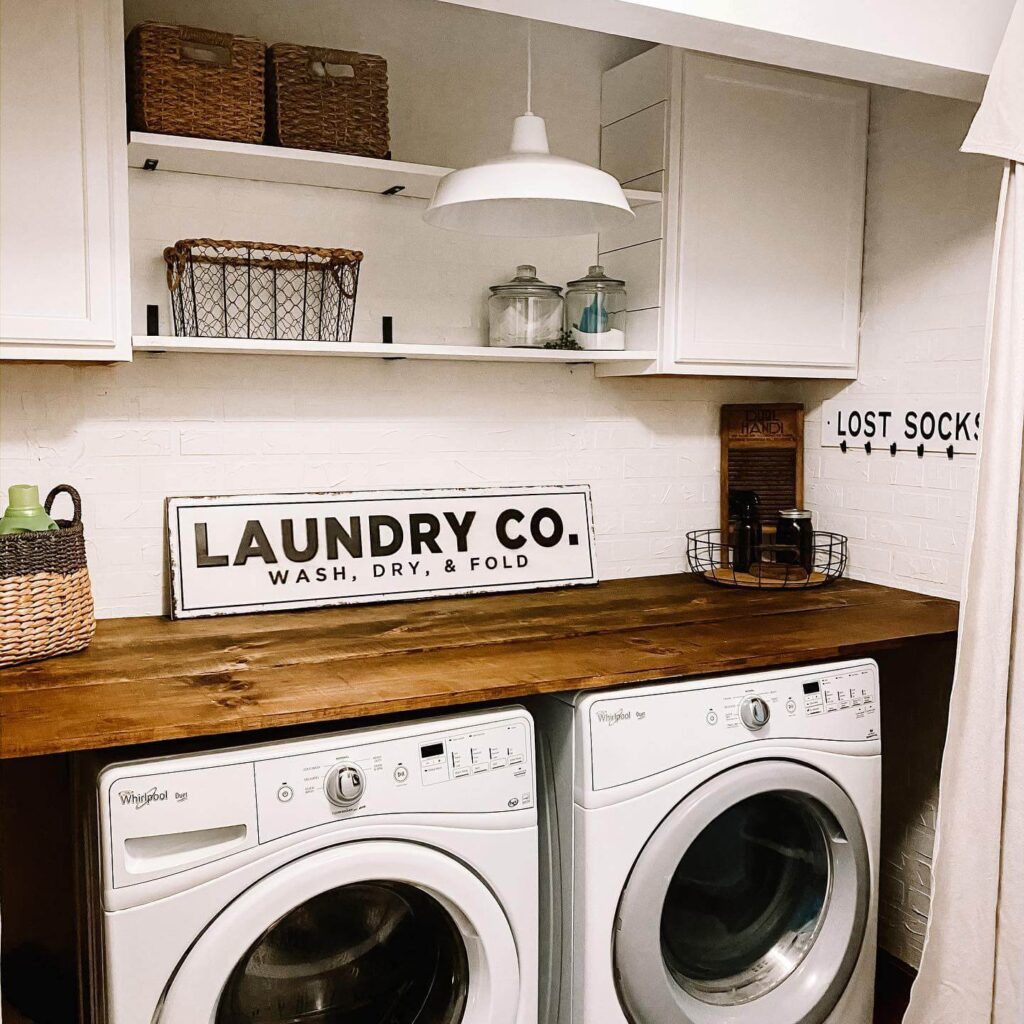 6. Laundry Closet with Patterned Wallpaper and Hanging Bar