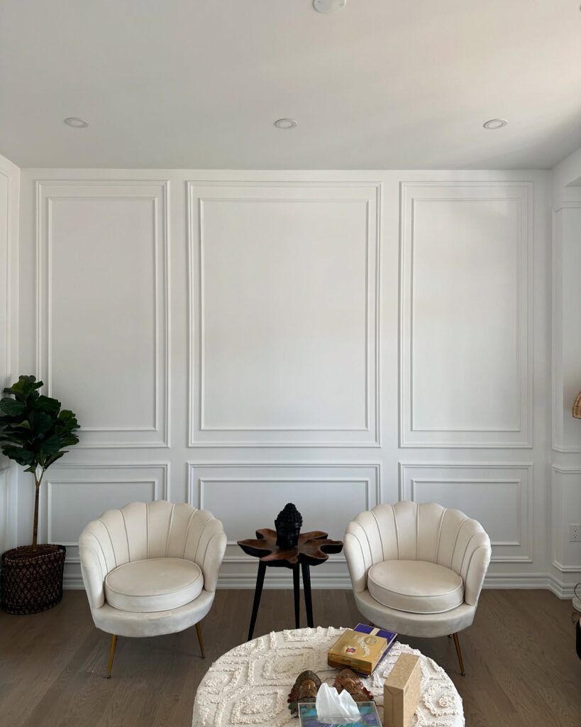 7. Bold Contrast with Black Panel Wainscoting